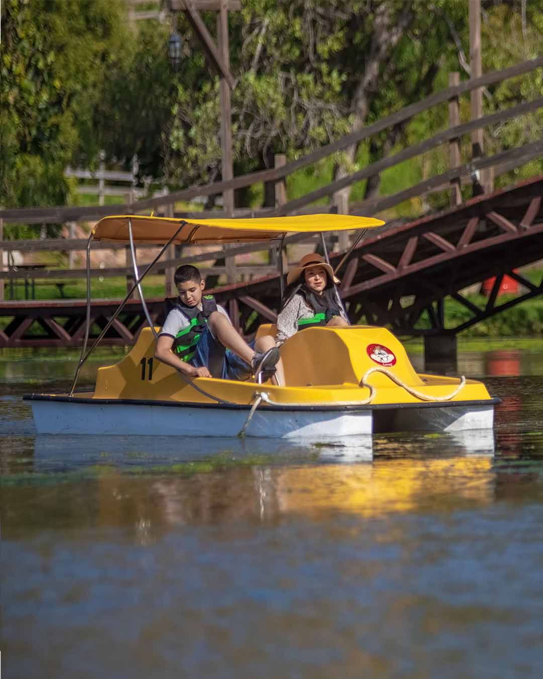 Visitors using a yellow pedal boat on the lake at Las Cañadas